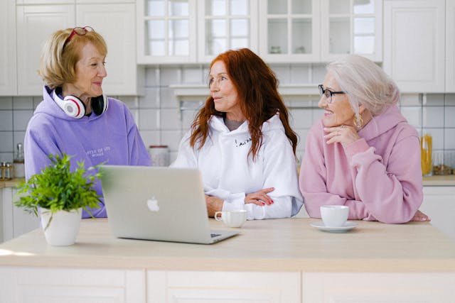positive image of older women working together and using a computer