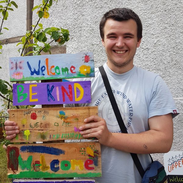 Rowan holding a Welcome sign