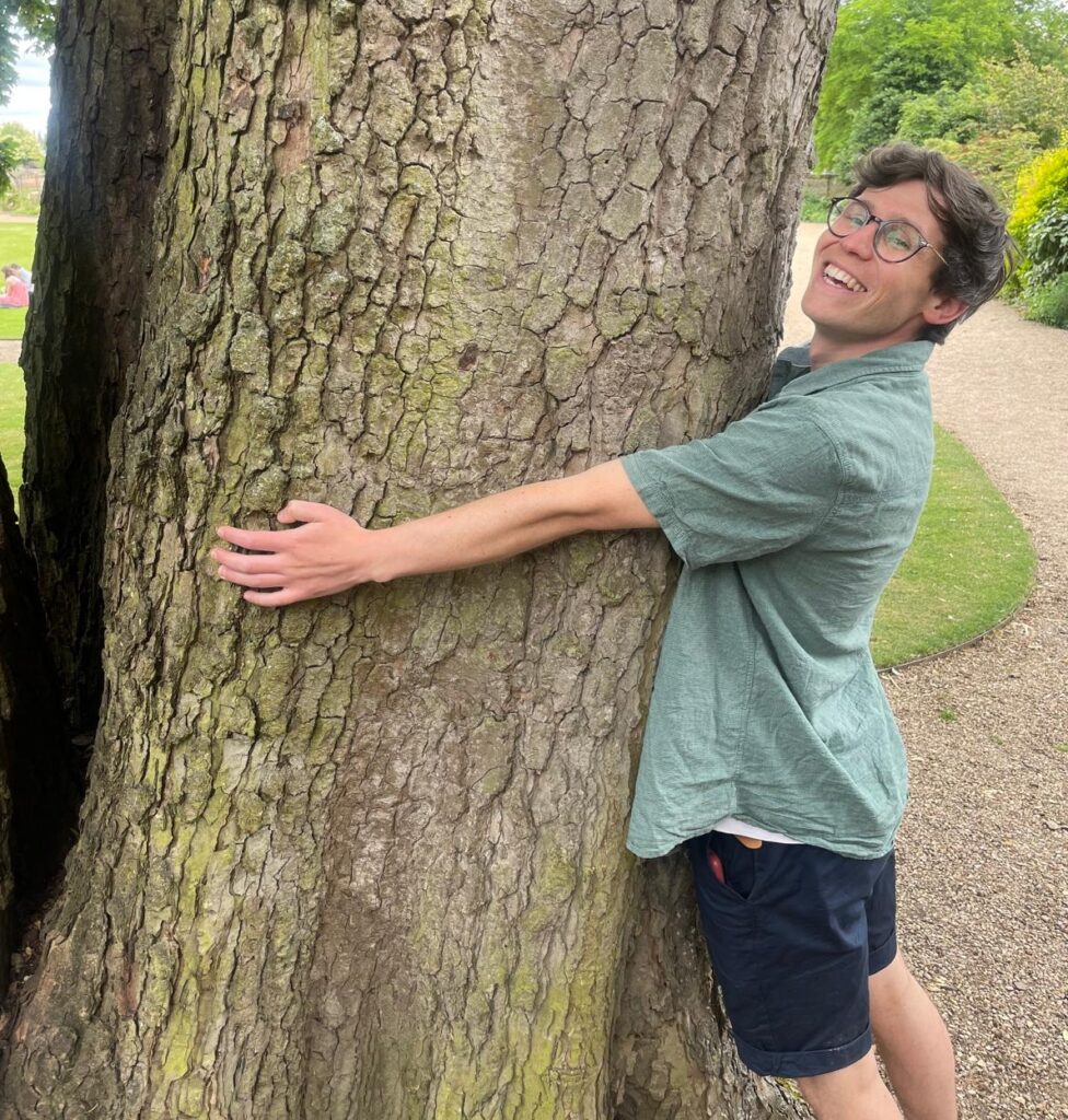 Lewis hugging a tree.