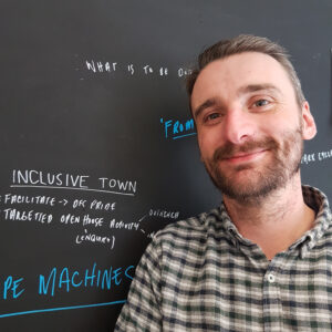 Martin O'Neill from the Stove network standing in front of the brainstorming blackboard in his office