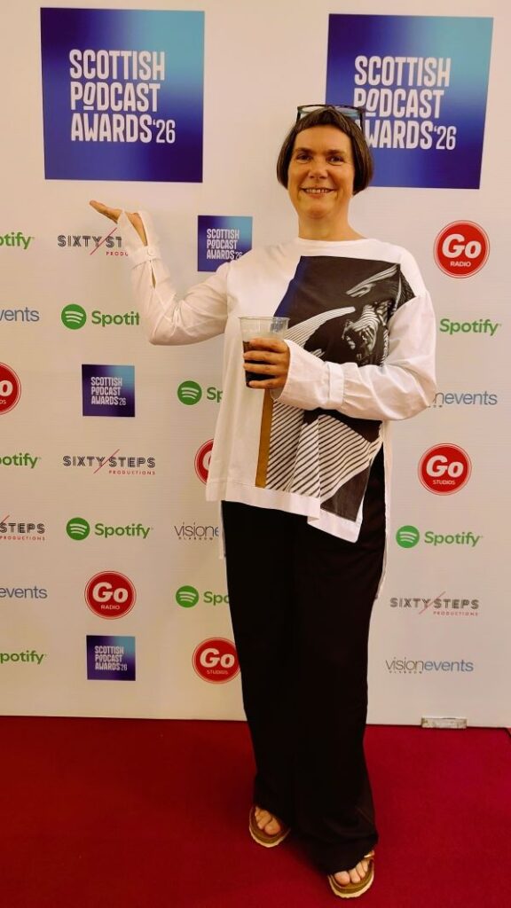 Kaska Hempel standing at the red carpet at the Scottish Podcast Awards