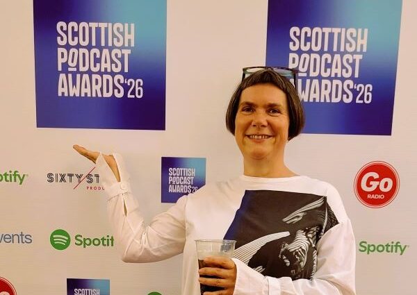 Kaska Hempel standing at the red carpet at the Scottish Podcast Awards
